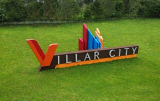 Villar City signage displayed on landscaped grounds in Metro Manila.